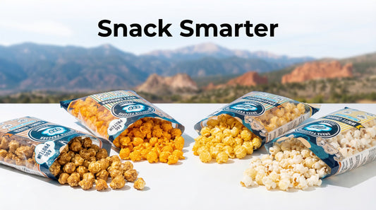 protein-popcorn-bags-on-table-with-colorado-springs-mountains-in-background