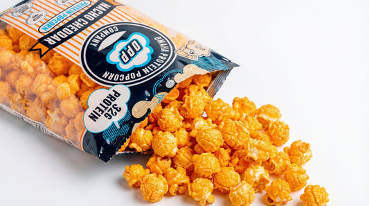 premium-protein-popcorn-bag-with-high-protein-label-and-spilled-popcorn-on-clean-background