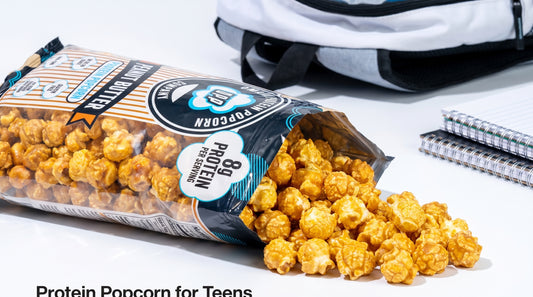 high-protein-popcorn-bag-with-popcorn-and-teen-backpack-on-clean-background