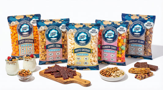 high-protein-popcorn-next-to-various-protein-snacks-on-clean-background