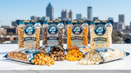 hero-image-of-omaha-protein-popcorn-with-atlanta-skyline-background