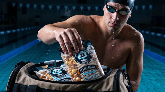 swimmer-grabbing-protein-popcorn-from-gym-bag-poolside