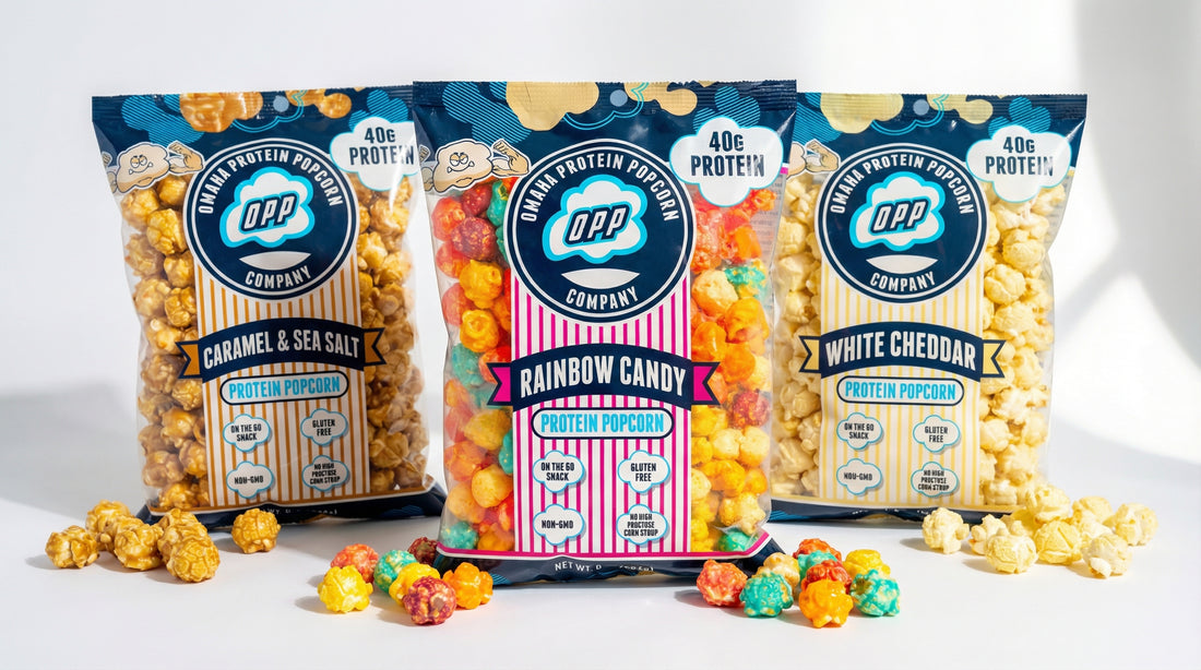 hero image of omaha protein popcorn bags with scattered popcorn and clean bright background
